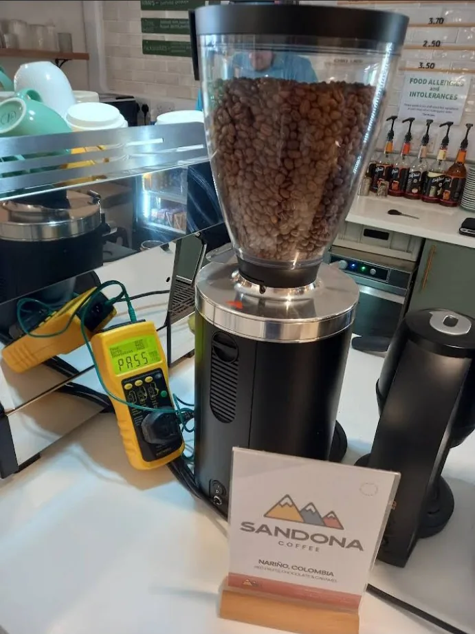 Coffee grinder being PAT tested in a café