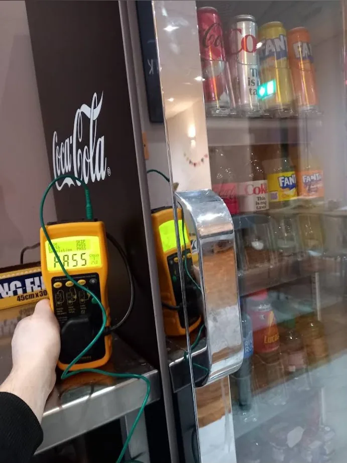 Commercial drinks refrigerator being PAT tested